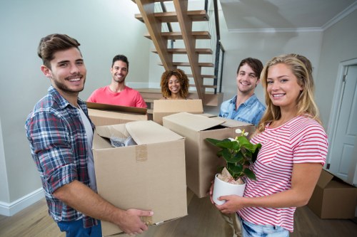 Professional office movers handling desks and equipment in Millwall